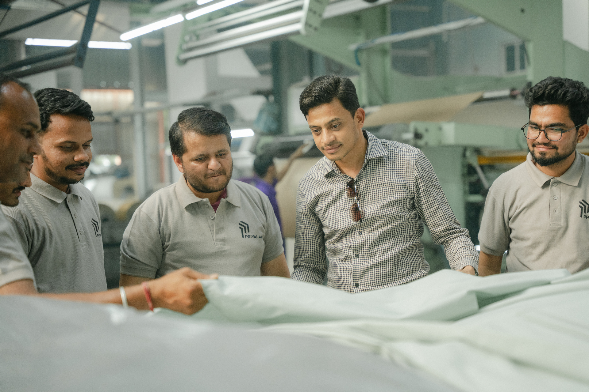 Priyalaxmi team reviewing fabric quality